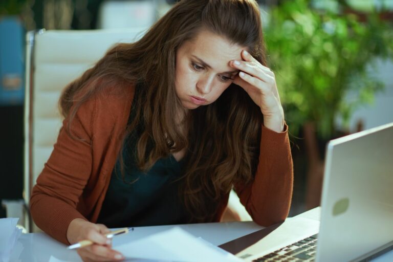 Stressed,Young,Small,Business,Owner,Woman,Working,With,Documents,In